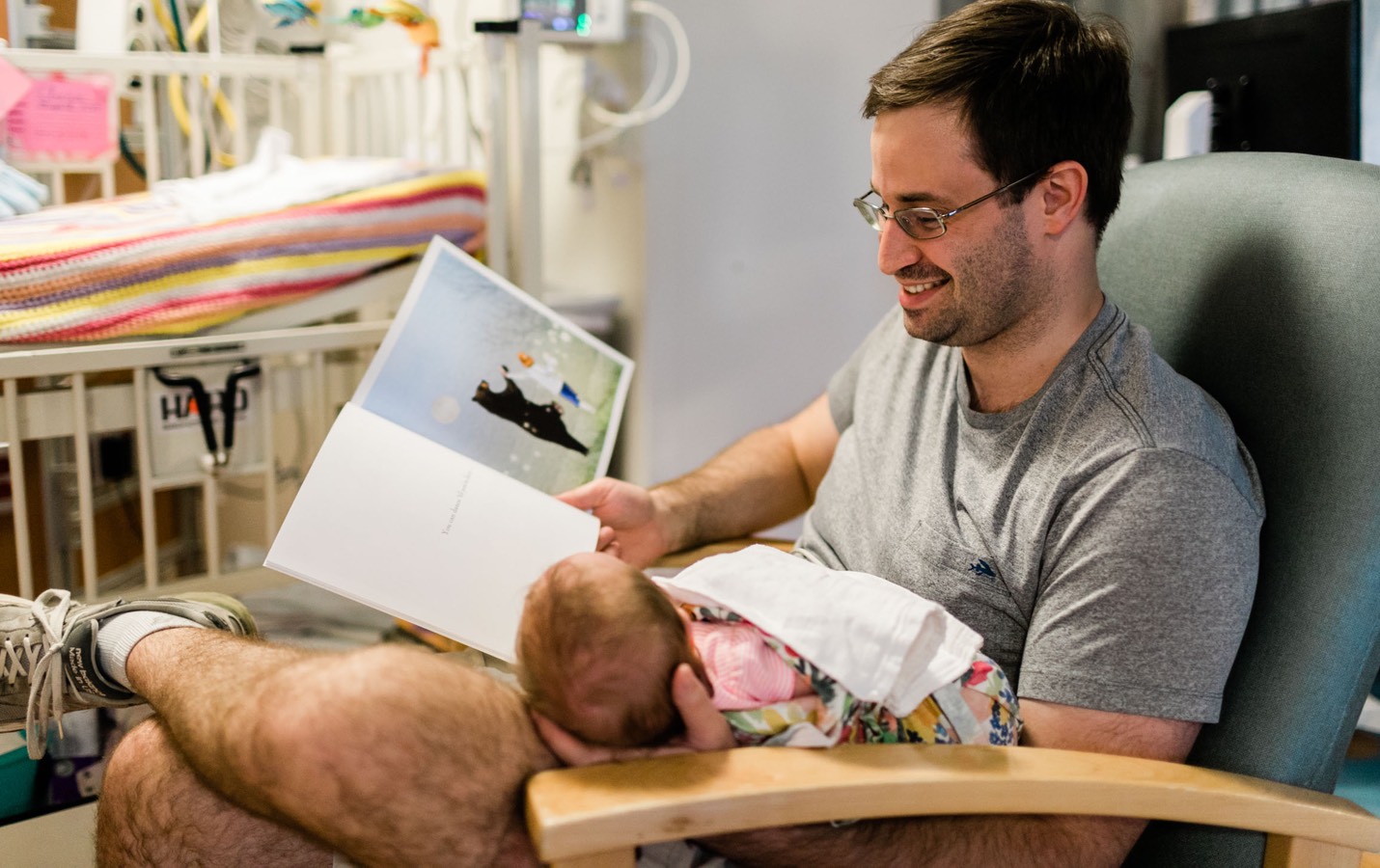 Dad reading to baby